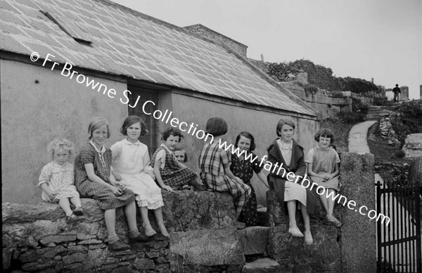 CHILDREN SITTING ON WALL